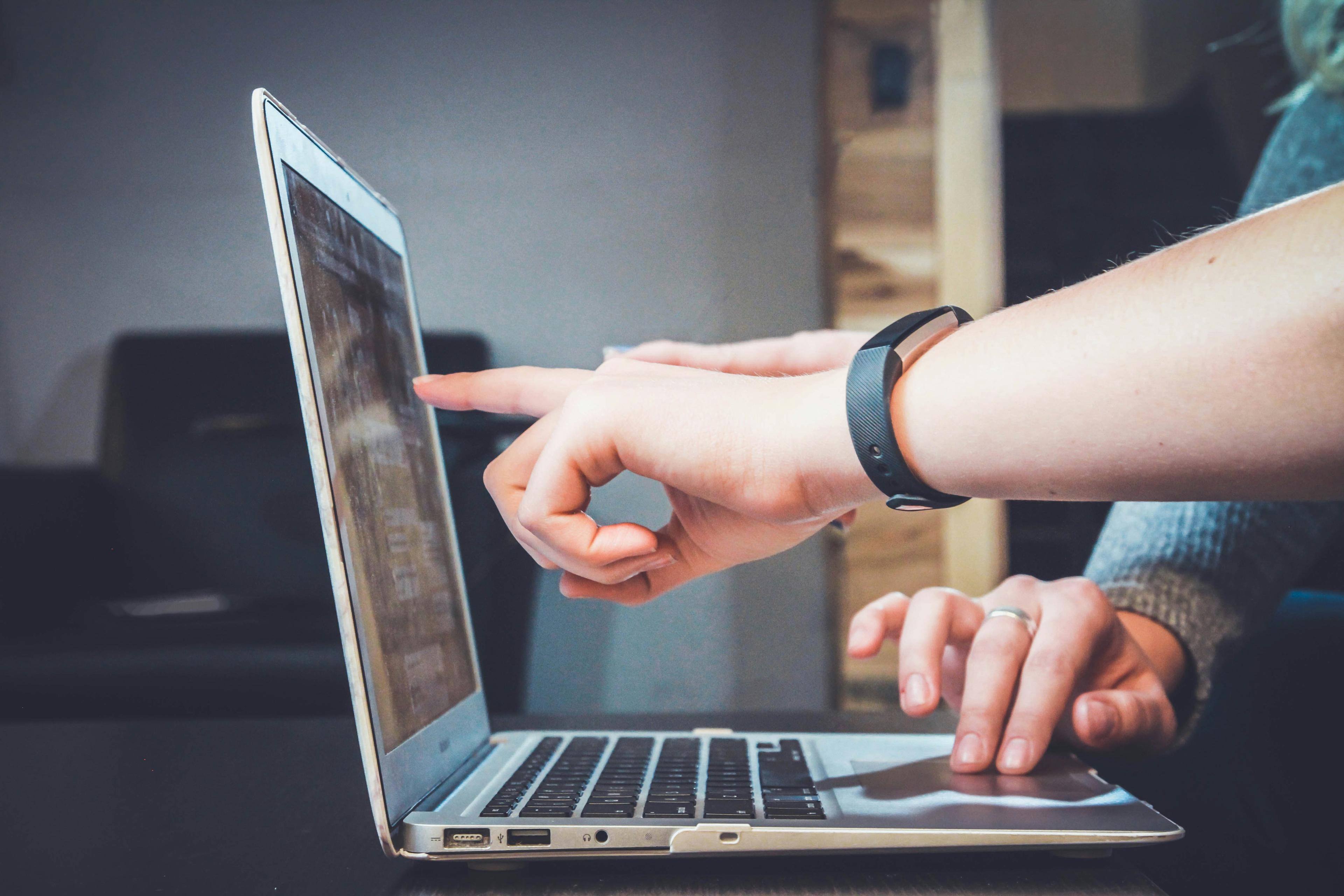Person working on a laptop with technology and connectivity graphics representing CRM email marketing automation