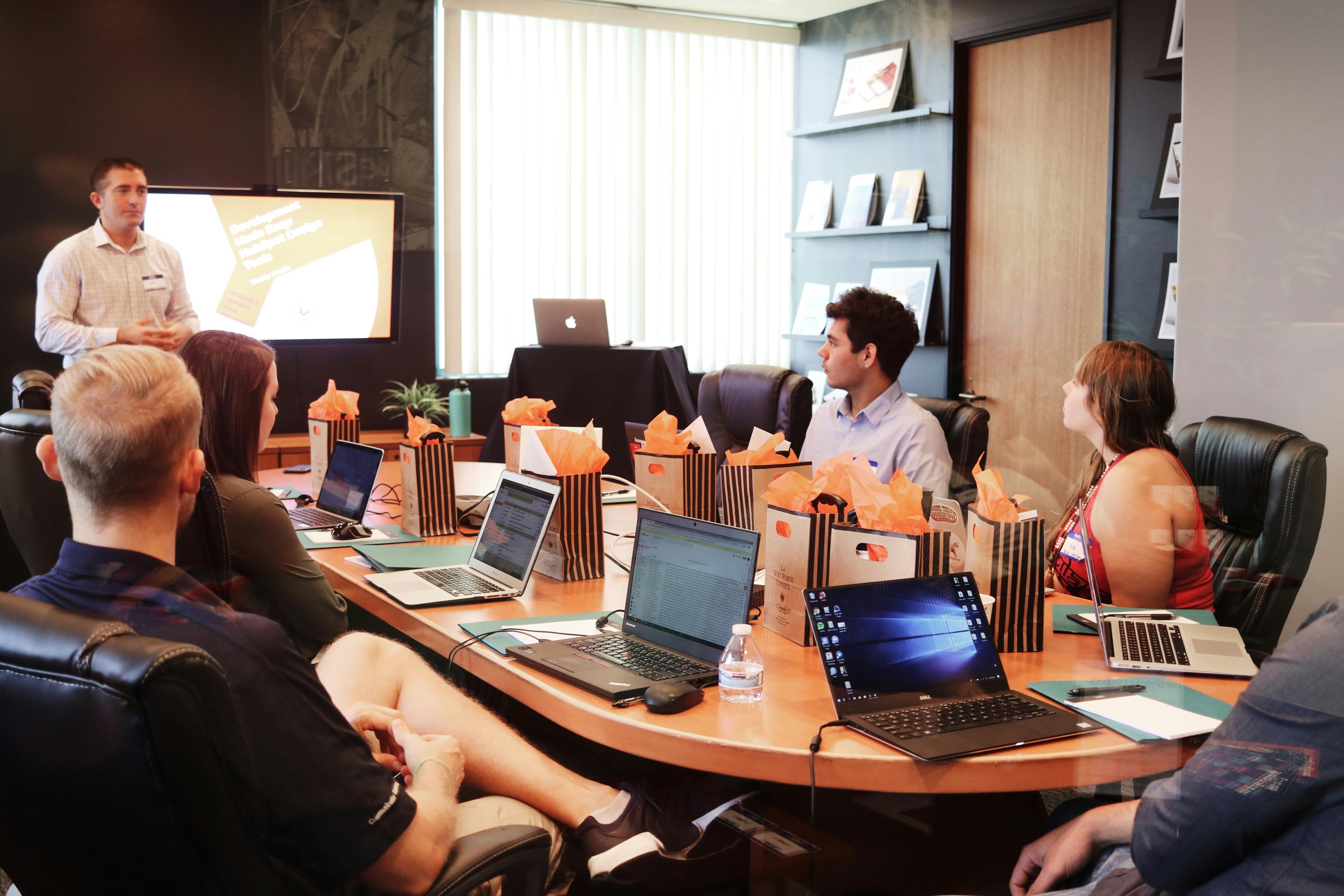 Business team discussing SaaS pricing strategy around a conference table