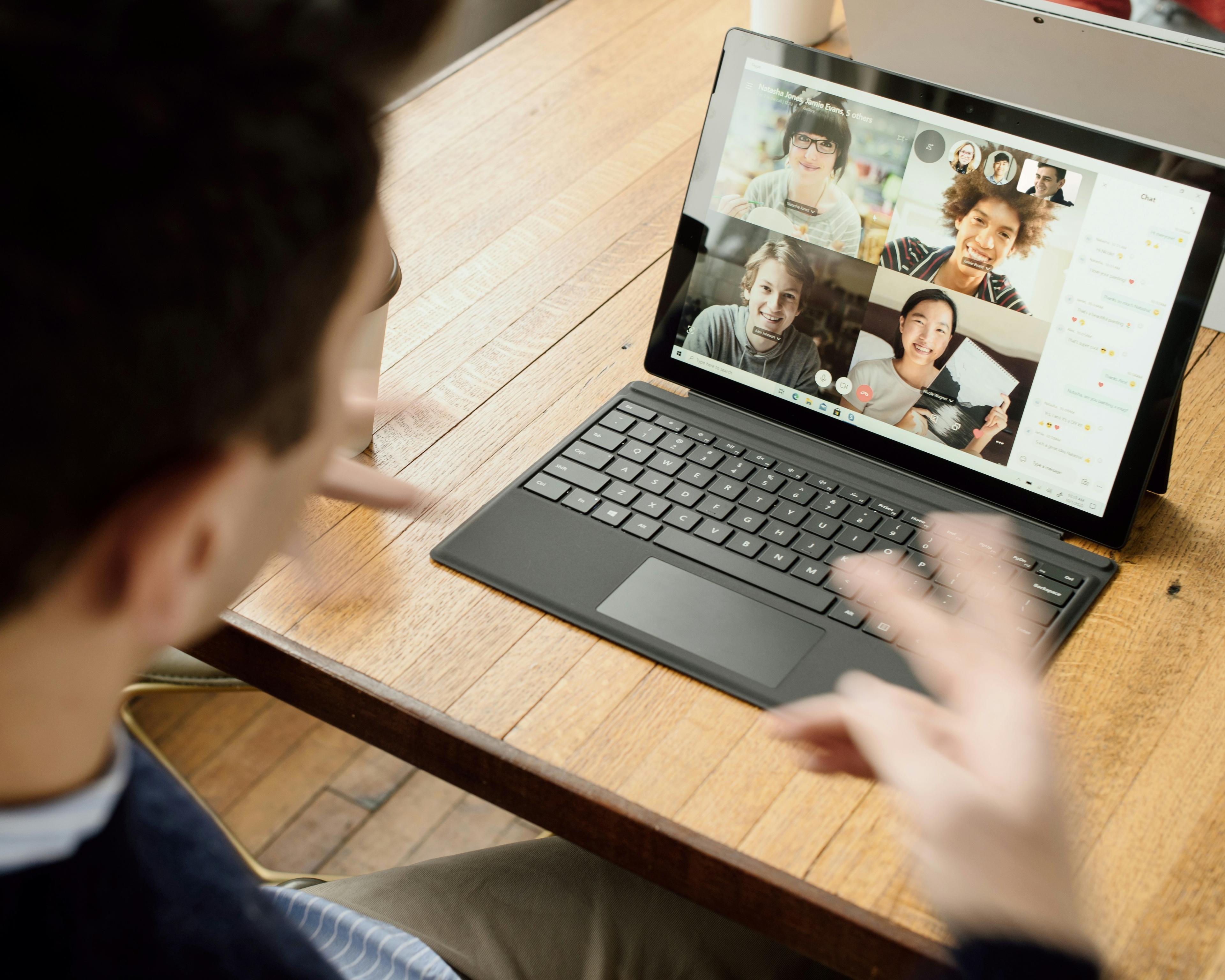 Sales professional using AI meeting assistant technology on laptop during business call